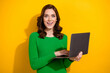 © deagreez - Photo of astonished pretty lady hold netbook unbelievable online shop offer isolated on yellow color background