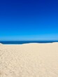 Blue seascape, sandy sea coastline, empty wild beach, pure blue sky, sea horizon