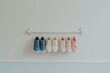  an inverted rack of and shoes on a white wall in