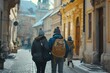 A couple is seen walking down a charming cobblestone street. This image can be used to depict a romantic stroll or a leisurely walk in a picturesque setting