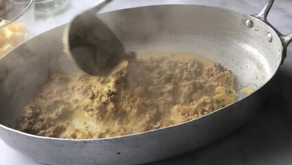 Wall Mural - Preparing a fresh casserole with minced meat sauce, savoy cabbage and cheese by woman´s hands.