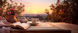 Morning landscape overlooking a lush valley and traditional tea service on a wooden table with white tablecloth, roses in bloom, and sunrise in the background. Travel, home comfort, relaxation