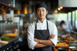 © Michael - Asian chef sushi master standing in a restaurant kitchen with hands crossed