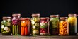 Assorted pickled veggies in glass jars presented on a table.