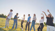 © Довидович Михаил - Funny jolly friends dancing in the city meadow in the evening.