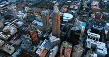 Distancing From The Highest Building In Charlotte, NC, USA. Aerial View Of The City Panorama At Dusk.