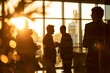 © Emanuel - Multiple silhouettes of business people interacting in an office setting
