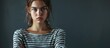 Young teenager girl wearing casual striped t shirt skeptic and nervous disapproving expression on face with crossed arms negative person. Copy space image. Place for adding text