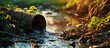 Sewage pipe outfall into the river water pollution and environmental damage concept selective focus. Copy space image. Place for adding text