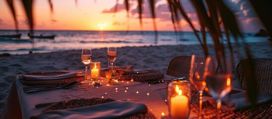 Poster - Romantic dinner on the beach with sunset candles with palm leaves and sunset sky and sea Amazing view honeymoon or anniversary dinner landscape Exotic island evening horizon romance for a coupl