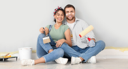 Wall Mural - Happy young couple during painting of wall at home