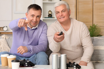 Poster - Mature brothers watching TV at home