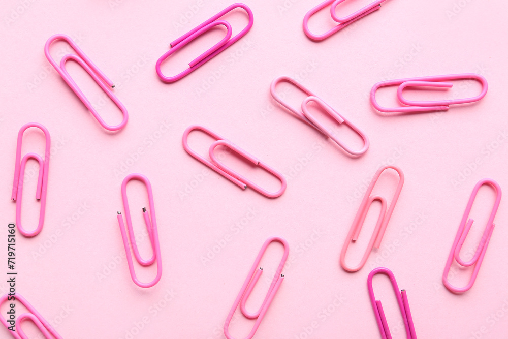 Set of paperclips on pink background