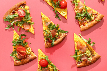 Wall Mural - Pieces of delicious pizza with tomatoes and arugula on red background