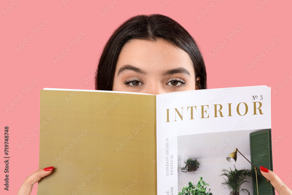 Young woman reading magazine on pink background, closeup