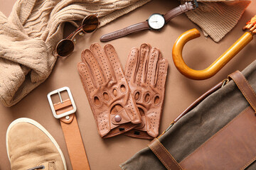 Wall Mural - Composition with leather male gloves and different accessories on color background