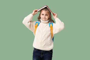 Sticker - Little schoolgirl with book  on green background