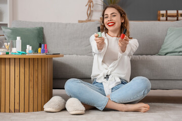 Poster - Beautiful young happy woman with bottles of nail polish in living room