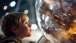 A closeup of a young child gazing in wonder at a model spaceship, representing the potential for the future generation to view space tourism as a normal and attainable goal.
