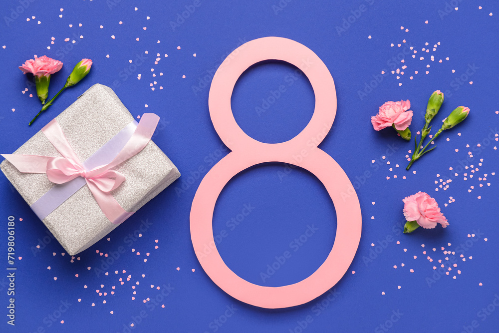 Figure 8 with gift box and beautiful flowers on blue background. International Women's Day