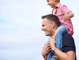 Canvas Print - Father, outdoor and carrying son on shoulders for childhood playing, sunshine and wellness by blue sky. Parent, child and happiness in nature for bonding together, love and fun on outside on vacation