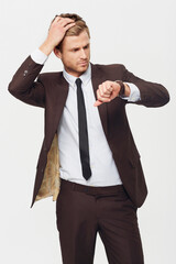 Wall Mural - Businessman, watch and checking time in late, stress or schedule deadline against a white studio background. Attractive young man looking at wristwatch in suit for mistake, business or fashion style