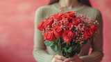 Fototapeta Morze - Young woman hands holding bouquet red roses with lights in background, romantic and charm atmosphere background. Valentine concept.