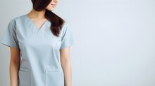 A Nurse In Uniform Providing Care, Isolated On A Calm Light Grey.