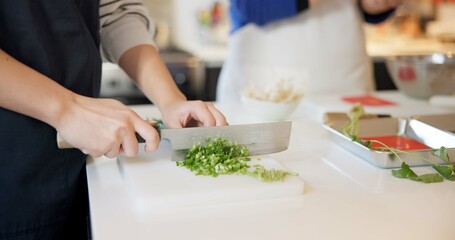 Wall Mural - Chef hands, knife and spring onion in restaurant, chopping and prepare ingredients for catering services. Person, cutting vegetables and cooking food for diet, nutrition and health at Japan Tokyo