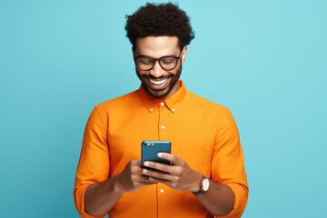 Poster - A man in an orange shirt using his cell phone. Perfect for illustrating modern technology and communication