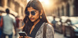 © sadi - Indian woman in sunglasses using smartphone, modern international communication concept