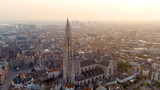 Fototapeta Nowy Jork - Antwerp, Belgium - July 21, 2023: Spire with the clock of the Cathedral of Our Lady (Antwerp). City Antwerp is located on river Scheldt (Escaut). Summer morning, Aerial View