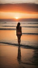 Beautiful Woman In A Bikini Watching The Sunset At The Beach