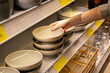 © puhimec - Female hand holding bowl from a shelf in homeware store.