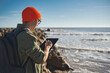 © Fotografia Juan Reig - Young marine biologist studying marine fauna with an electronic tablet on the seashore. Control of the environment.