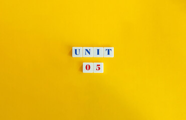 Wall Mural - unit 5. text on block letter tiles and icon on flat background. minimalist aesthetics.