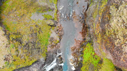 Canvas Print - Aerial view of beautiful Stjornarfoss waterfall on a wet rainy day