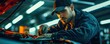 © Milan - Mechanic working on broken car engine at garage service.  Mechanic maintenance concept