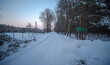 Iście zimowe , śnierzne krajobrazy. Tablica z nazwą (Czarna Glina )miejscowości w lesie droga poprzez śnieg.