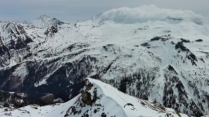 Wall Mural - Aerial view of snow mountain range landscape with moving clouds. Alps mountains, Austria, 4k