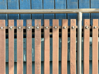 Sticker - old iron and wooden fence in a sunny day