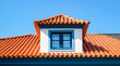 Roof shingles with garret house on top of the house. red  Ceramic tiles on the roof background