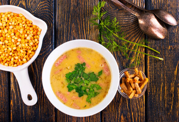 Wall Mural - pea soup in bowl, pea soup with smoked ham and croutons