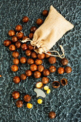 Poster - Organic Macadamia nut on wooden table, helthy food