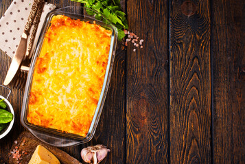 Sticker - Rectangular glass bowl filled with mashed potato, underneath which is fish in cheese sauce.