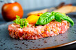 © tycoon101 - Top view of raw minced meat with liquid egg yolk for preparation of meatball placed on gray plate
