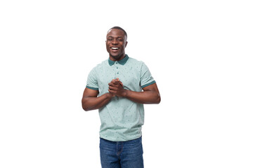 Wall Mural - young handsome smiling african man dressed casually on studio background