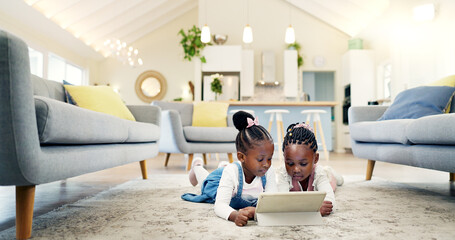 Canvas Print - Black girl children on ground with tablet and relax, elearning or watch cartoon movie, sisters at home and screen time. Young female kids, streaming online and subscription to education app or film