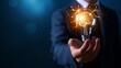 © Anastasiia Havelia - A businessman in a business suit holding a lit light bulb. The burning light bulb symbolizes an idea.