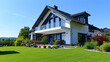 © Nico Vincentini - Idyllic German Home: Bright Facade with Lush Green Grass in Perfect Weather